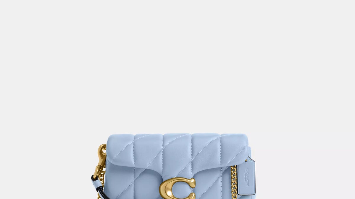 This Coach Tabby wristlet can double as a dainty clutch or cross-body bag, featuring a decorative chain strap and built-in card slots for added convenience.