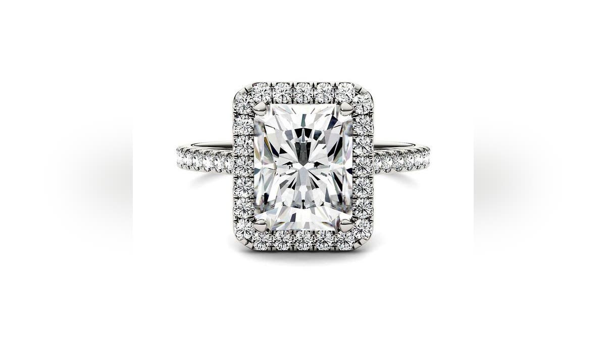 This captivating halo-style ring at Helzberg features a radiant-cut center Moissanite encircled by a halo of smaller diamonds.
