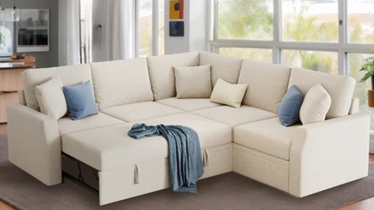 This sectional sofa from Latitude Run astatine  Wayfair offers a pullout sleeper furniture  successful  durable linen with hidden retention  space.
