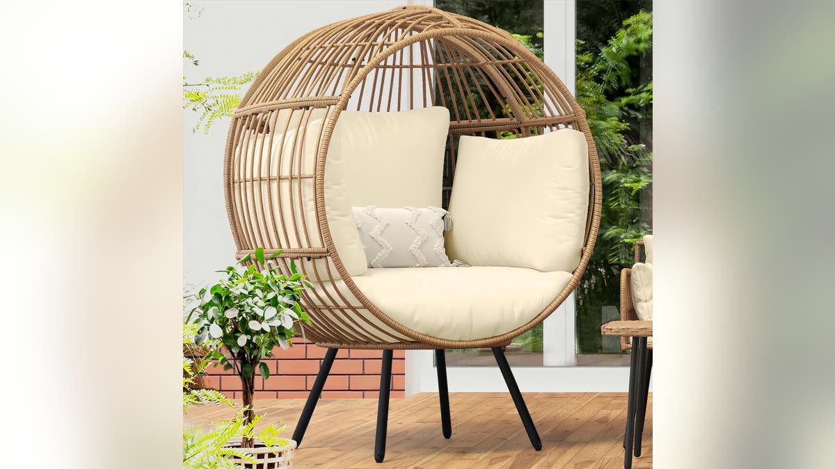This stylish wicker egg chair adds a contemporary and cozy touch to any outdoor space.