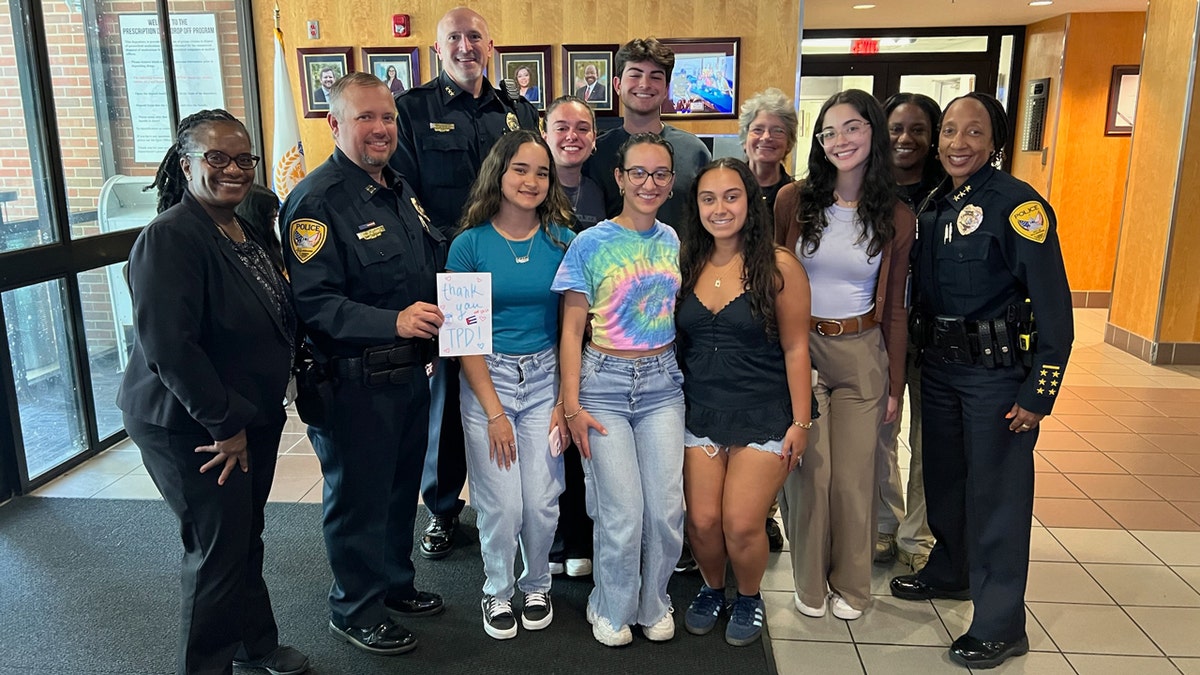 Members of Florida State University's Cuban-American Student Association pose for a photograph with some Tallahassee police officers.
