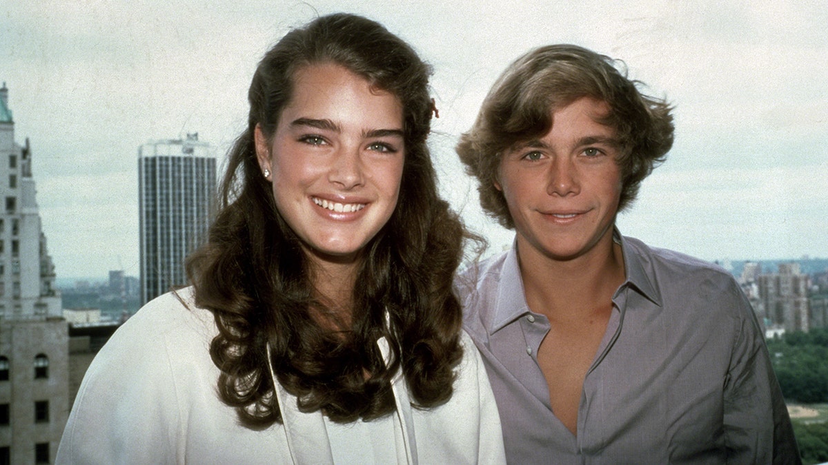 Brooke Shields and Christopher Atkins smiling and posing next to each other in New York City.