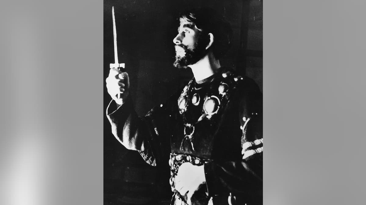 King Charles in costume acting out a scene.