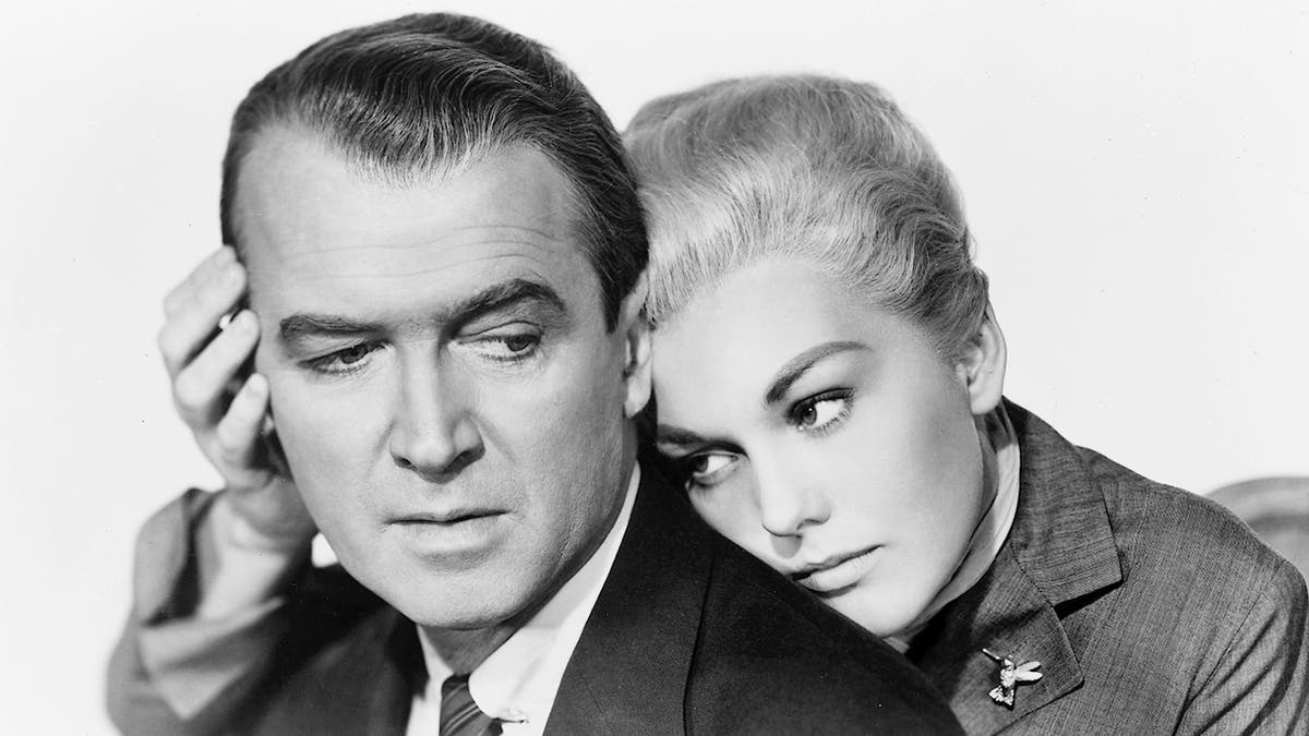 Kim Novak leaning on James Stewart in a scene from Vertigo