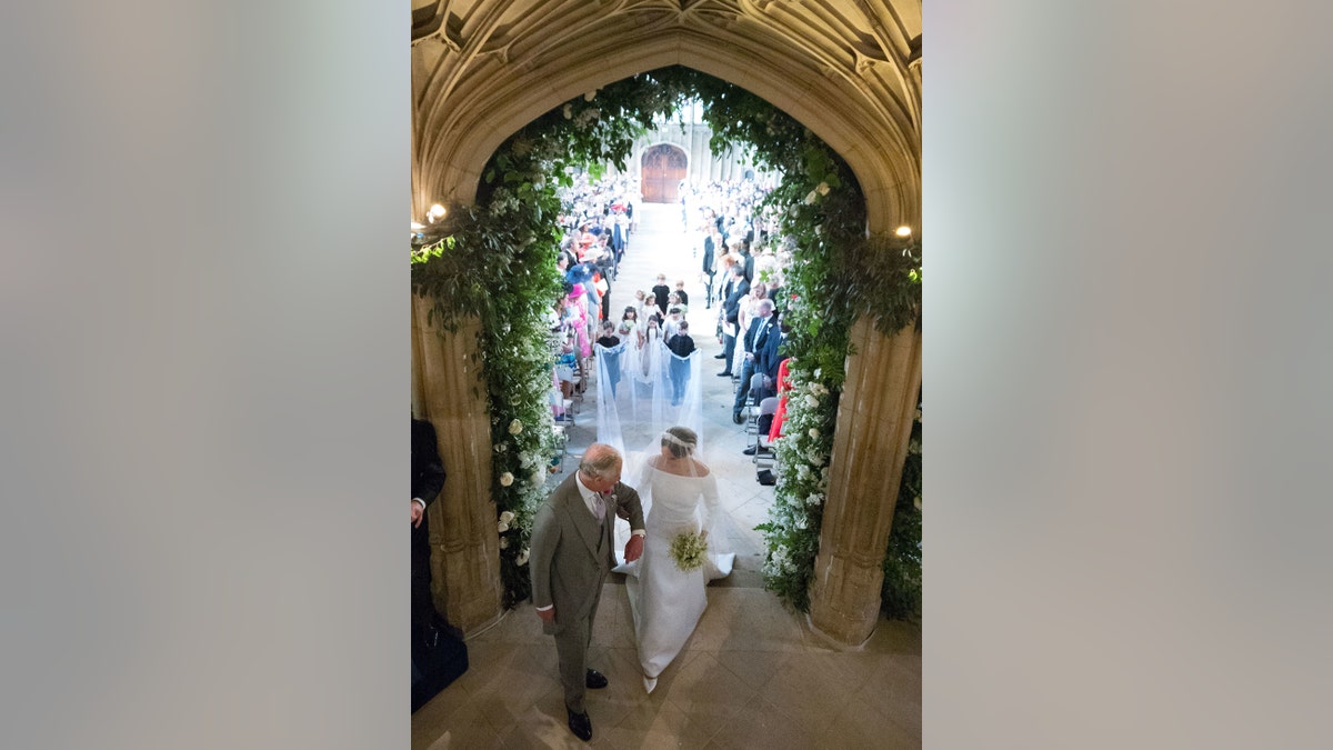 King Charles walking on Meghan Markle in the aisle on his wedding day.