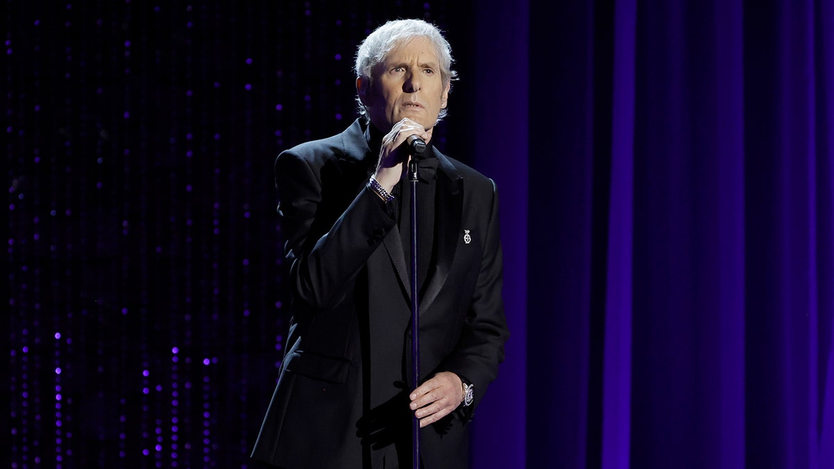 Michael Bolton on stage performing in all black.