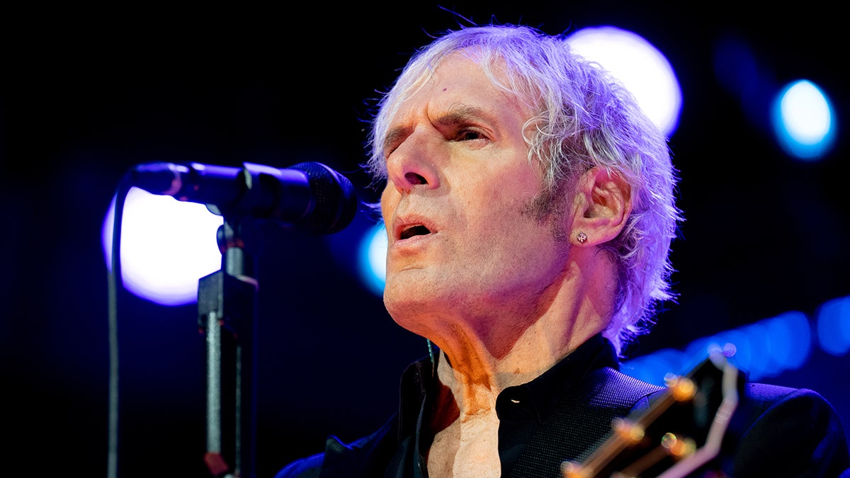 A close-up of Michael Bolton singing on stage.