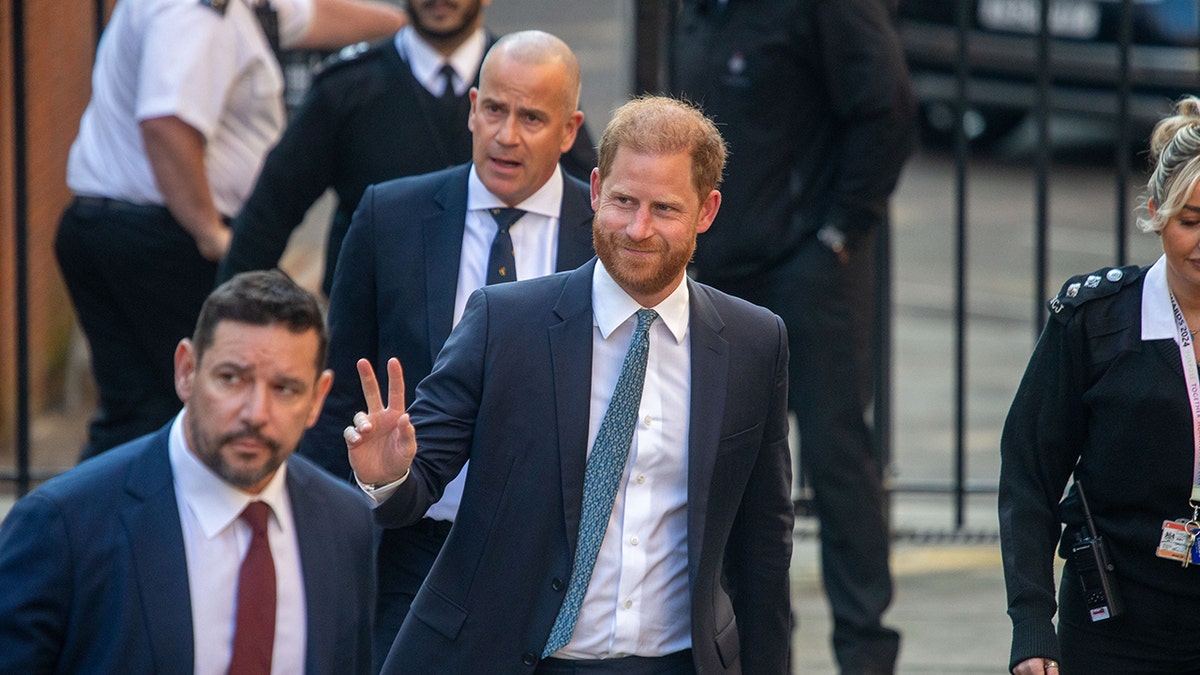 Prince Harry waves to the crowd.