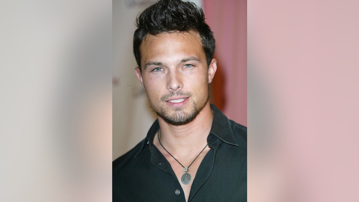 A close-up of Ricardo Medina Jr. wearing a black shirt and necklace.