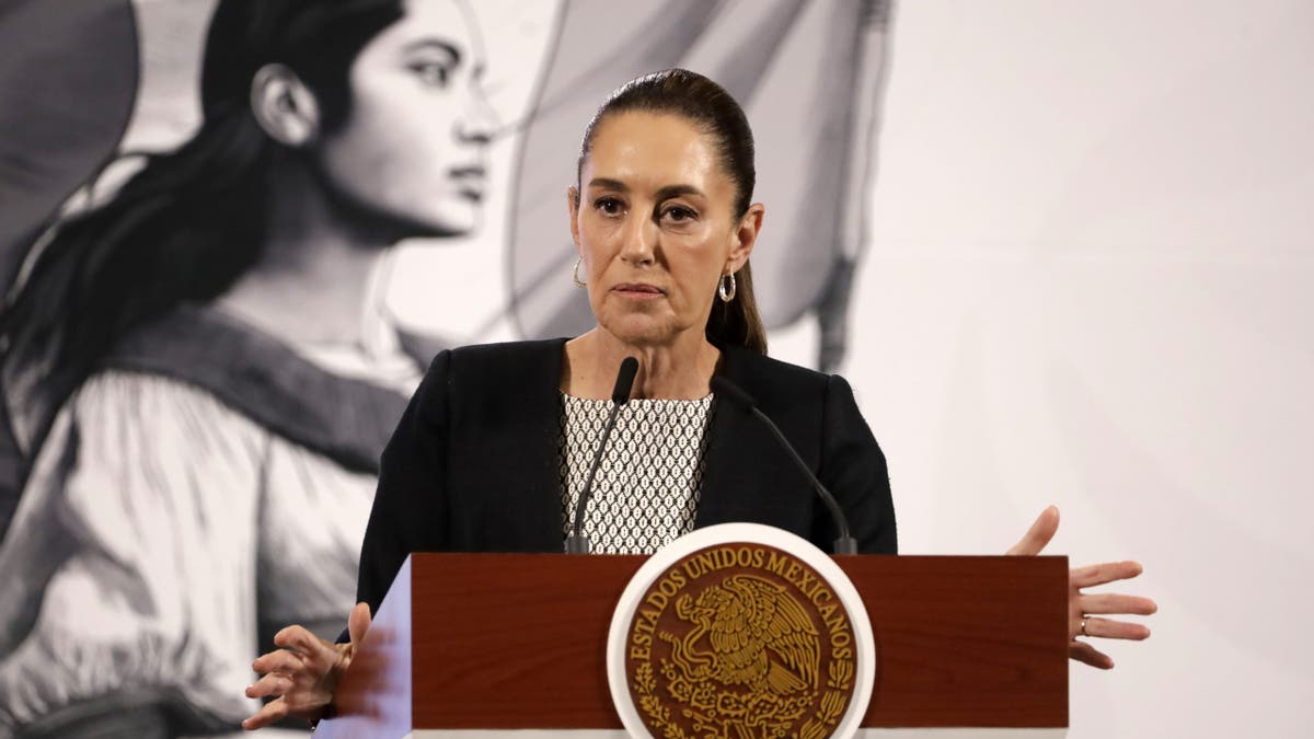 Mexican president speaking at podium while wearing black attire