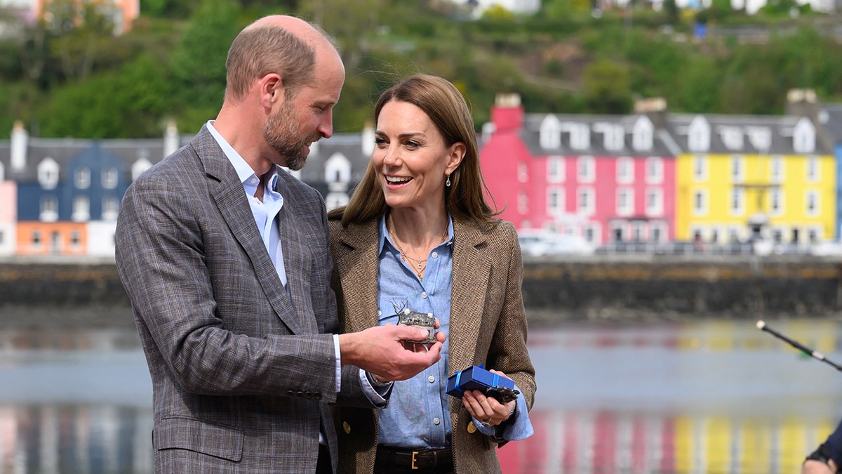 Prince William and Kate Middleton walking along the water in Tobermory, Scotland