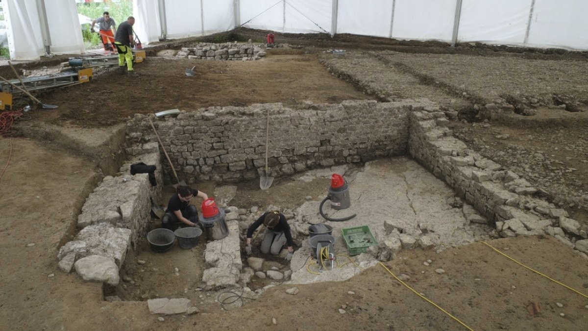 Archaeologists excavating stone building