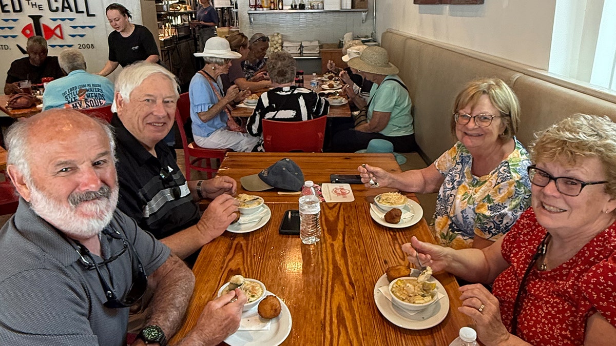 Two older men and 2 older women airs for a photograph wrong a Thomasville, Georgia, restaurant.