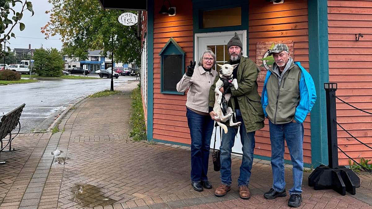 Tom Green with his parents holding his dog.
