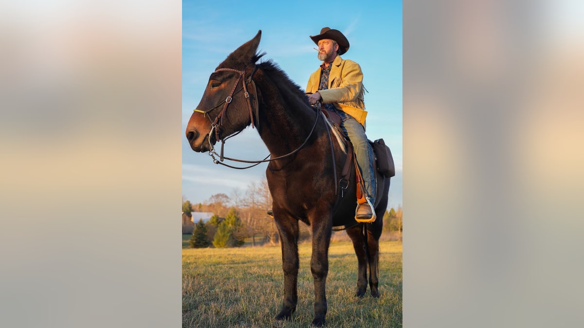Tom Green on top of his mule Fanny.
