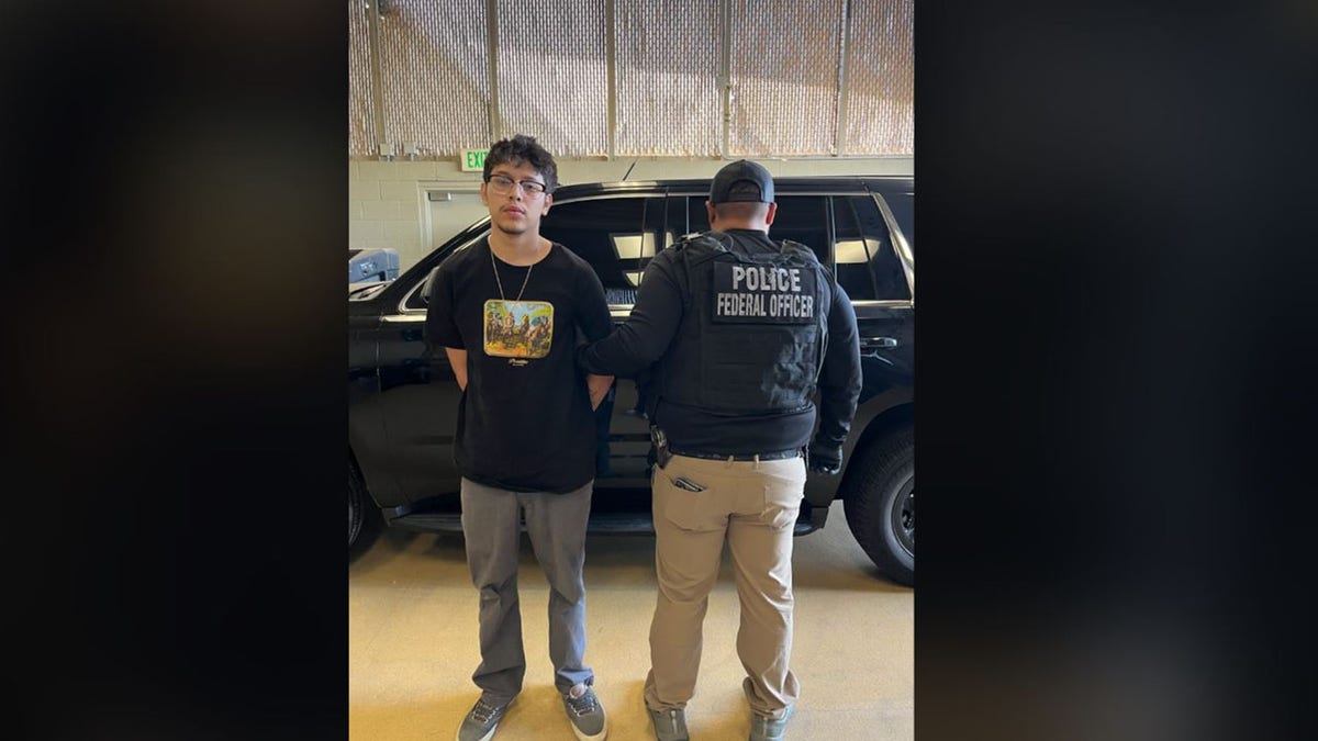 Gibram Torres, 22, pictured with an ICE agent