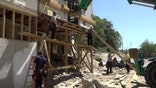 Construction crew rebuild a building destroyed by Hurricane Helene