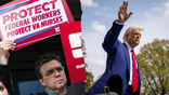 A protester, seen outside the Department of Veterans Affairs headquarters in Washington, D.C., is picured next to p