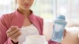 Woman scooping creatine