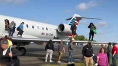 American Airlines passengers evacuate flight on wing of plane after landing in Georgia, video shows