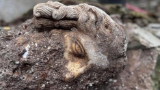 Archaeologists unearth strange head depicting Roman god beneath Catholic basilica