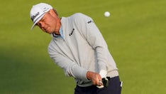 Patton Kizzire crawls in shrubbery to line up shot after wayward drive during the Masters