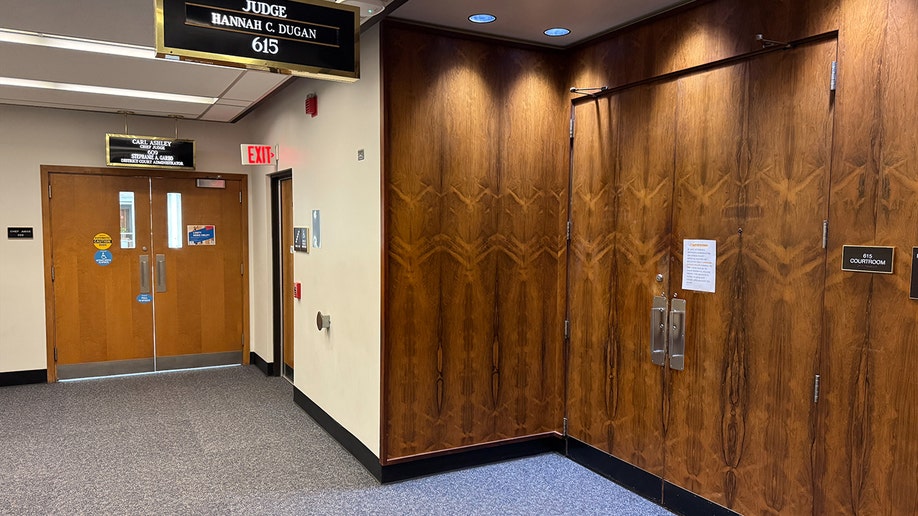 view outside Dugan's courtroom, with notice posted on door