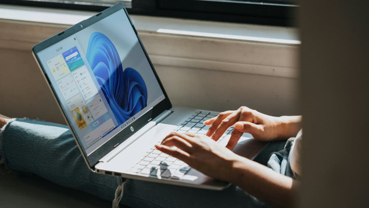 person typing on laptop