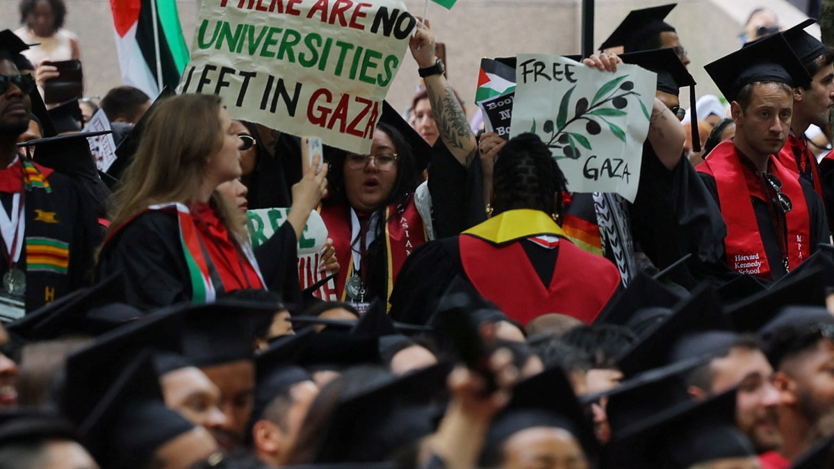 Graduating students hold a sign reading "There Are No Universities Left in Gaza" during the 373rd Commencement Exercises at Harvard University, amid the ongoing conflict between Israel and the Palestinian Islamist group Hamas, in Cambridge, Massachusetts, U.S., May 23, 2024.