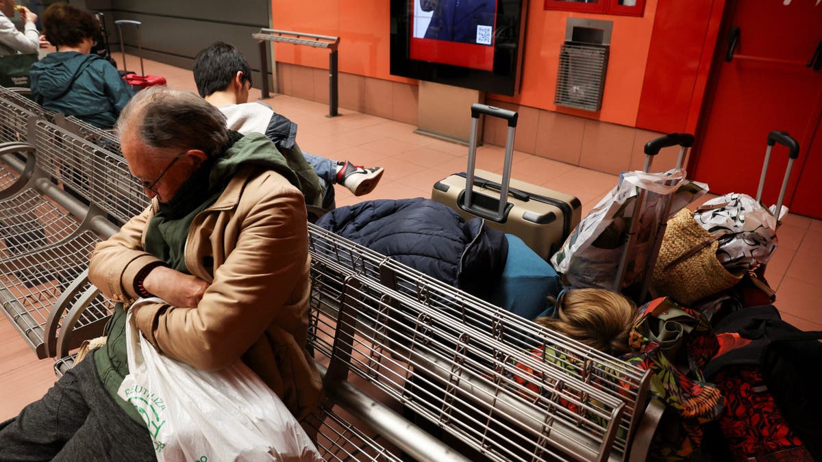 People wait at a railway station, following a huge outage that hit Spain and Portugal, in Madrid, Spain April 29, 2025