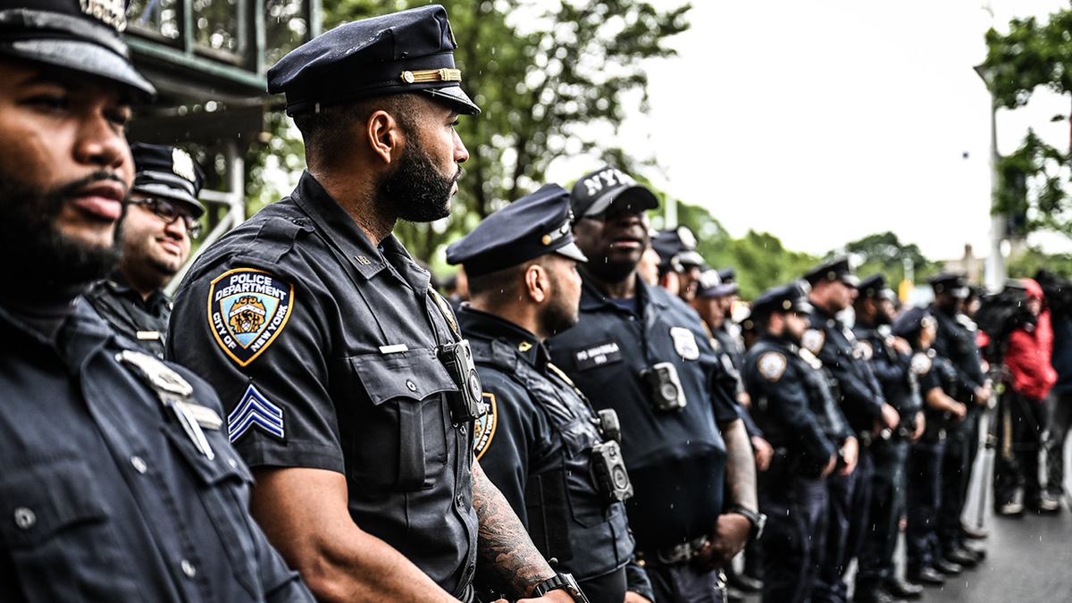 NYPD officers stand outside the hospital as Chowdhury Nafees is discharged.