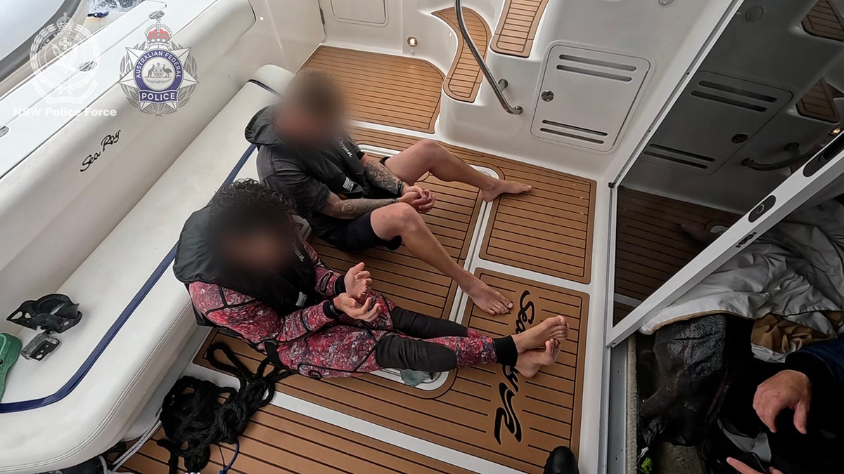 two men successful custody sitting aboard boat