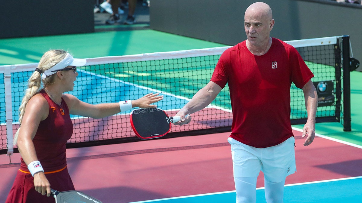 Andre Agassi and Anna Leigh Waters celebrate during game 1 of a Minto U.S. Open Pickleball Championships mixed pro doubles match  in Naples, Fla., on April 30, 2025.