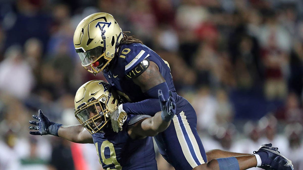 Akron Football players celebrate