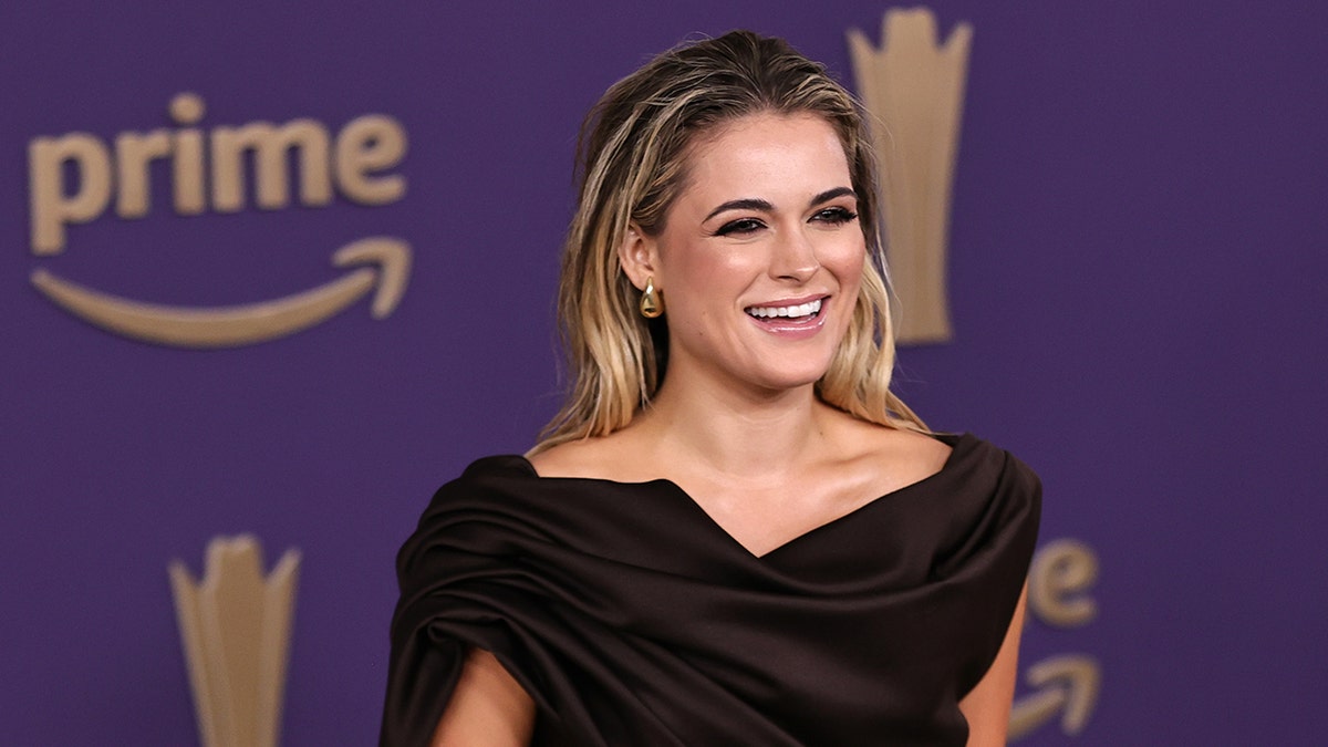 Alana Springsteen smiling connected nan reddish carpet