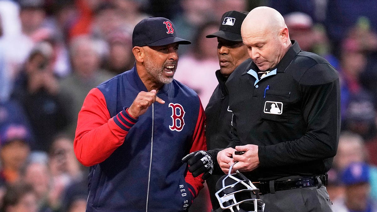 Alex Cora talks to the umpire