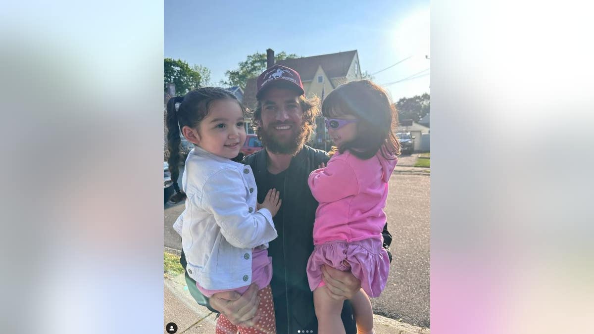 Fine holding his daughters