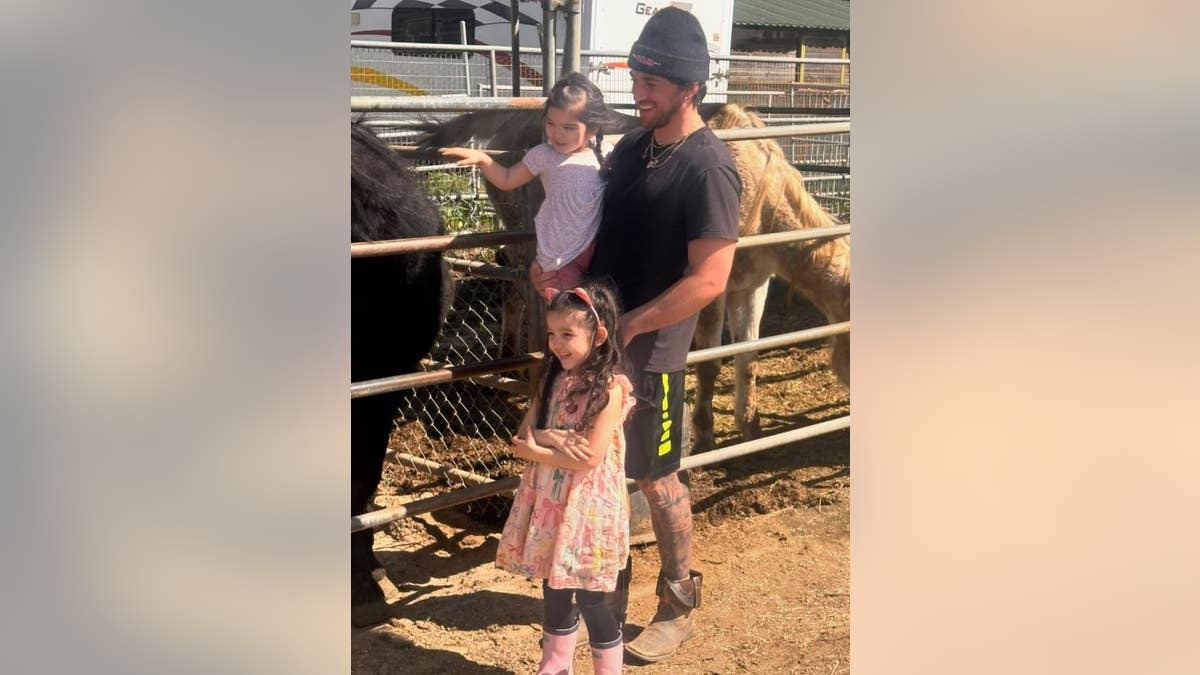 Alex Fine with his daughters at a farm