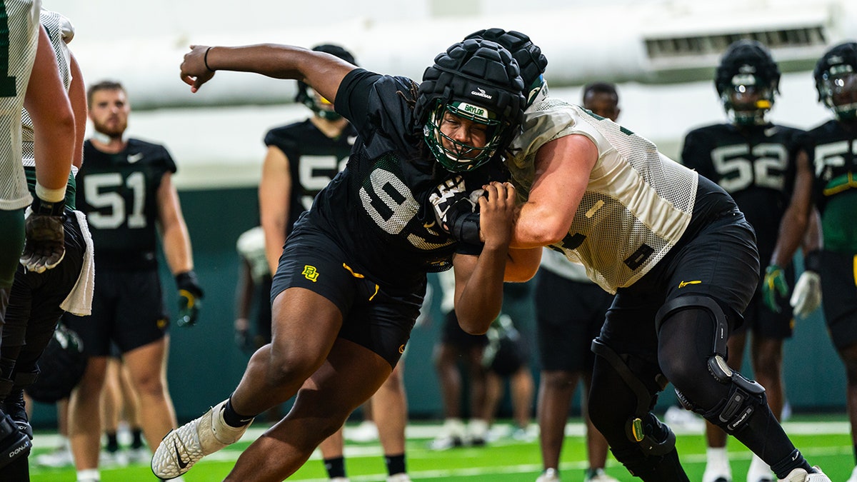 Alex Foster participates in drills