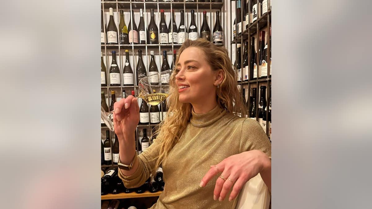 Amber Heard drinking champagne