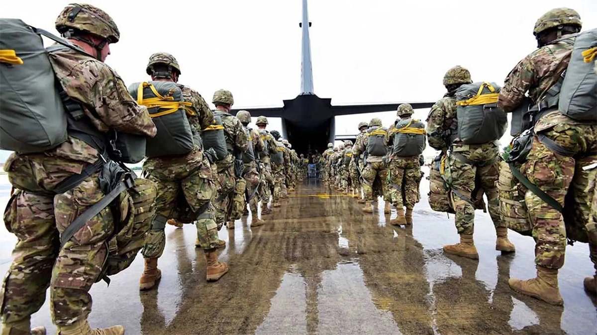 US Army paratroopers prepared to board a plane