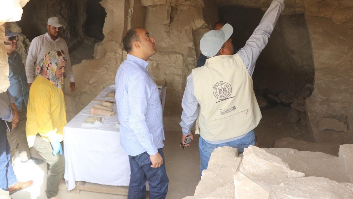 Officials looking around tomb