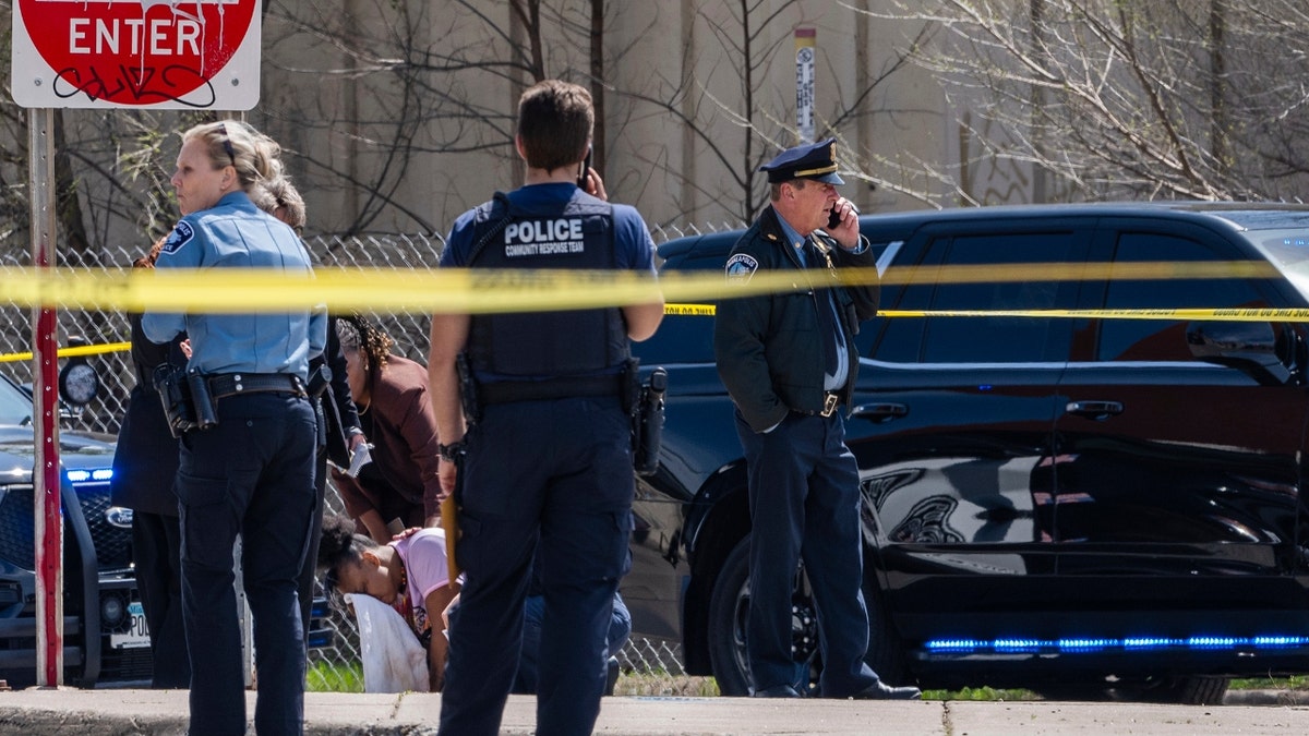 Police work on the scene as a bystander is shook up by the homicide in front of 2107 Cedar Ave S in Minneapolis, Minn., on Wednesday, April 30, 2025.