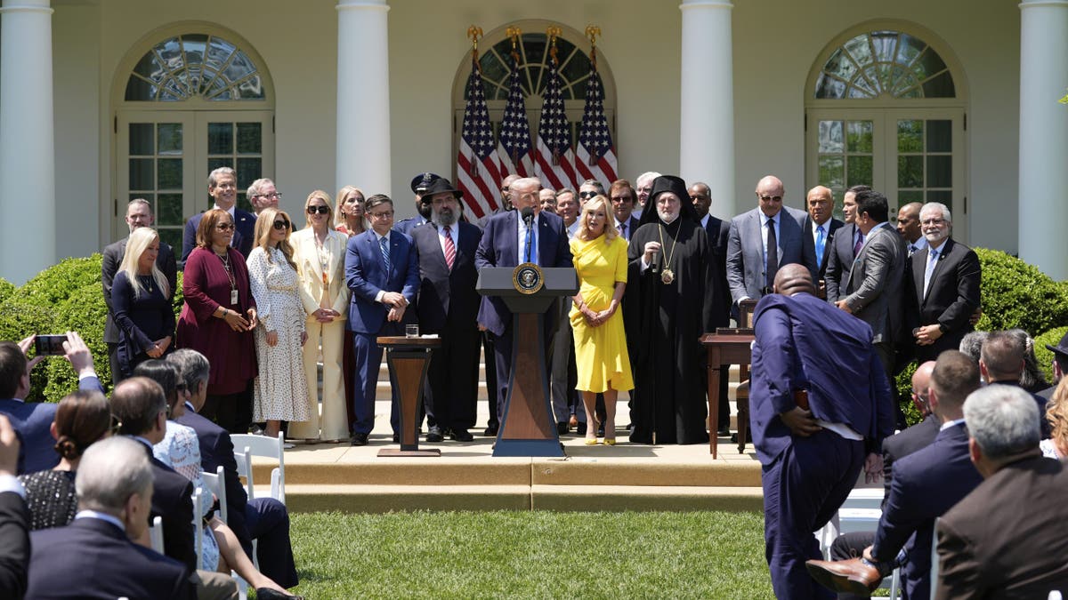 President Donald Trump calls people to the podium to stand with him during a National Day of Prayer event in the Rose Garden of the White House, May 1, 2025, in Washington. (Alex Brandon/The Associated Press)