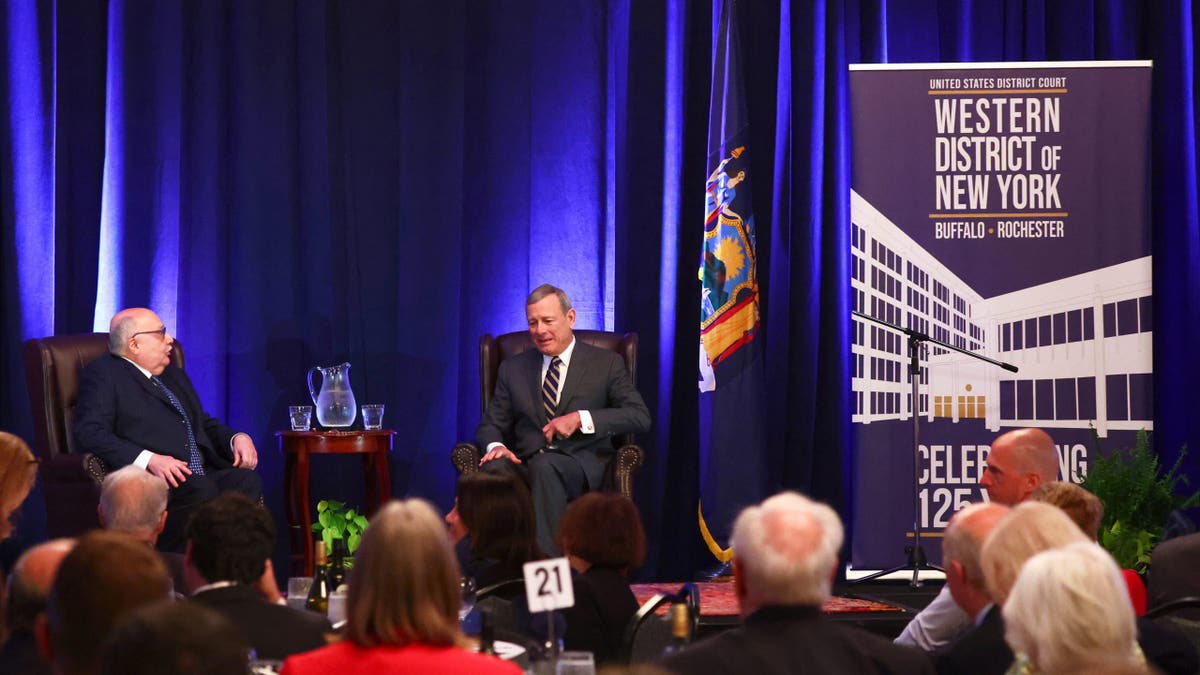 Chief Justice John Roberts, right, speaks with U.S. District Judge Lawrence J. Vilardo during a fireside chat at the 125th anniversary celebration of the United States District court for the Western District of New York, Wednesday, May 7, 2025, in Buffalo, N.Y. (AP Photo/Jeffrey T. Barnes