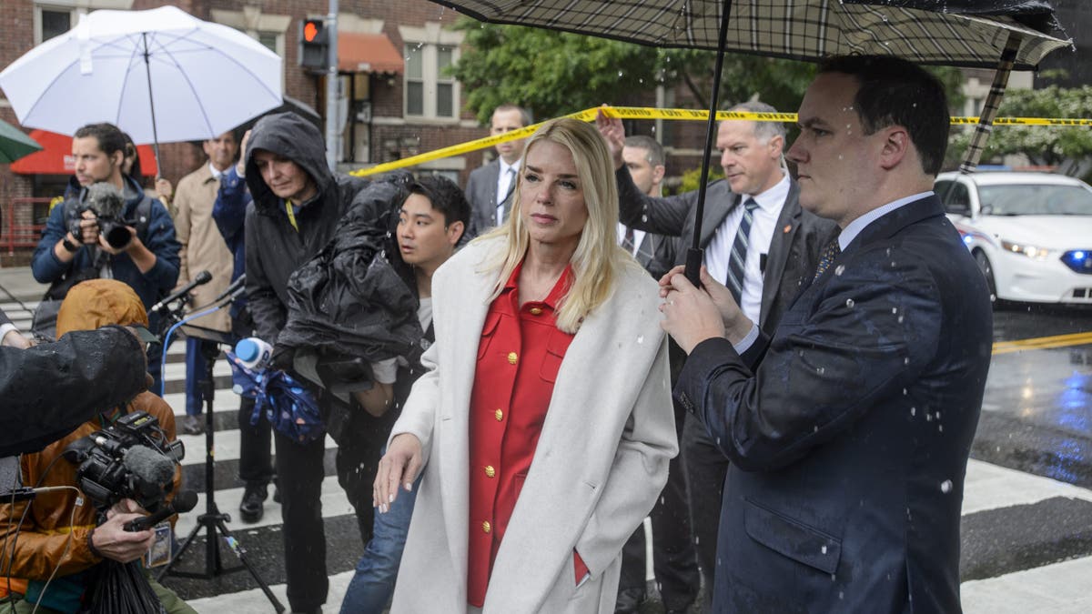 Attorney General Pam Bondi, center, arrives to talk with reporters as law enforcement work the scene after two staff members of the Israeli Embassy in Washington were shot and killed outside the Capital Jewish Museum, Thursday, May 22, 2025, in Washington. (AP Photo/Rod Lamkey, Jr.)