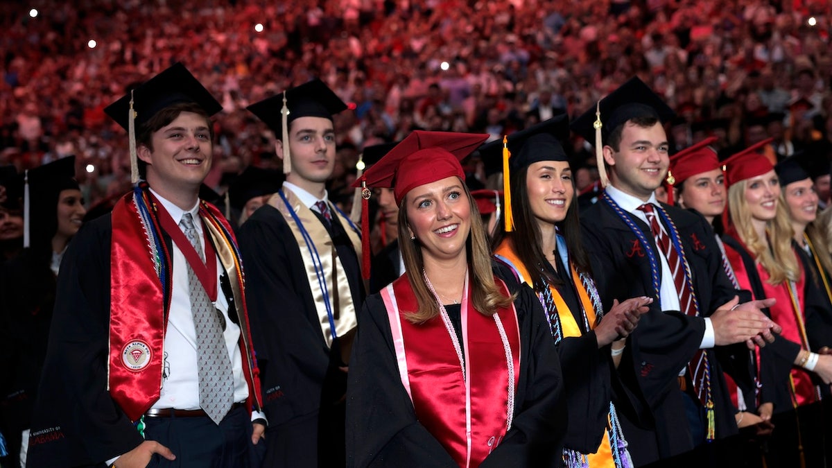 Graduating students listen to U.S. President Donald Trump deliver remarks at the Coleman Coliseum at the University of Alabama on May 01, 2025 in Tuscaloosa, Alabama. Trump's remarks come the day before official commencement ceremonies.