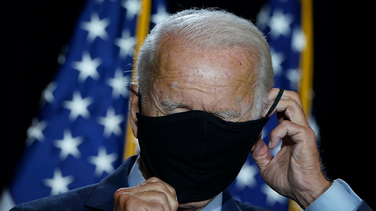 Then-presidential candidate Joe Biden puts his mask back on after delivering remarks following a coronavirus briefing with health experts at the Hotel DuPont on Aug. 13, 2020 in Wilmington, Delaware.