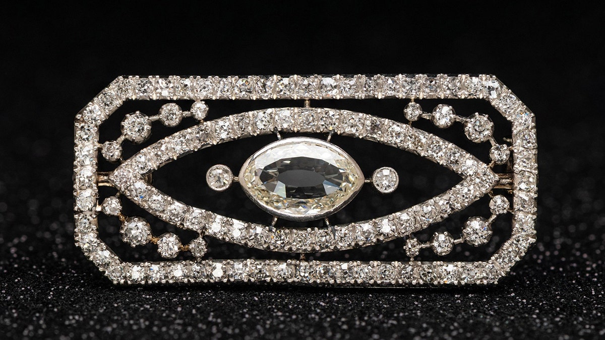 Art Deco brooch valued at £2.5K found hidden among costume jewellery. Release date May 26 2025. Can you spot the hidden treasure worth thousands among this box of old costume jewellery? An eagle-eyed auctioneer discovered a diamond brooch hiding in plain sight inside the innocuous box of jewellery which was brought along to a routine valuation day. The majority of items equated to being worth little more than £200 but the brooch turned out to be an Art Deco treasure, which later sold at auction for £2,300. It was spotted by Lisa Spence, head of jewellery at Richard Winterton Auctioneers, in Lichfield, Staffs., as she sifted through the collection. Lisa said: