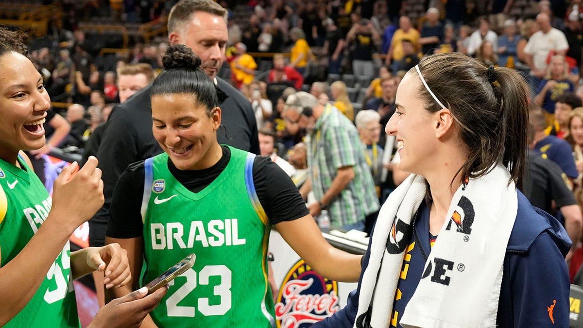 Caitlin Clark talks to Team Brazil players